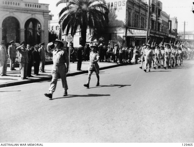 Major General H.W. Lloyd taking part in the salute from men of Second Army Headquarters in the Victory Loan March, Parramatta 1945
