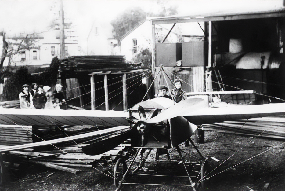 Billy Hart and his mother Maria sitting in a two seater monoplane Billy constructed at his father’s timberyard 1912. Image source: National Library of Australia