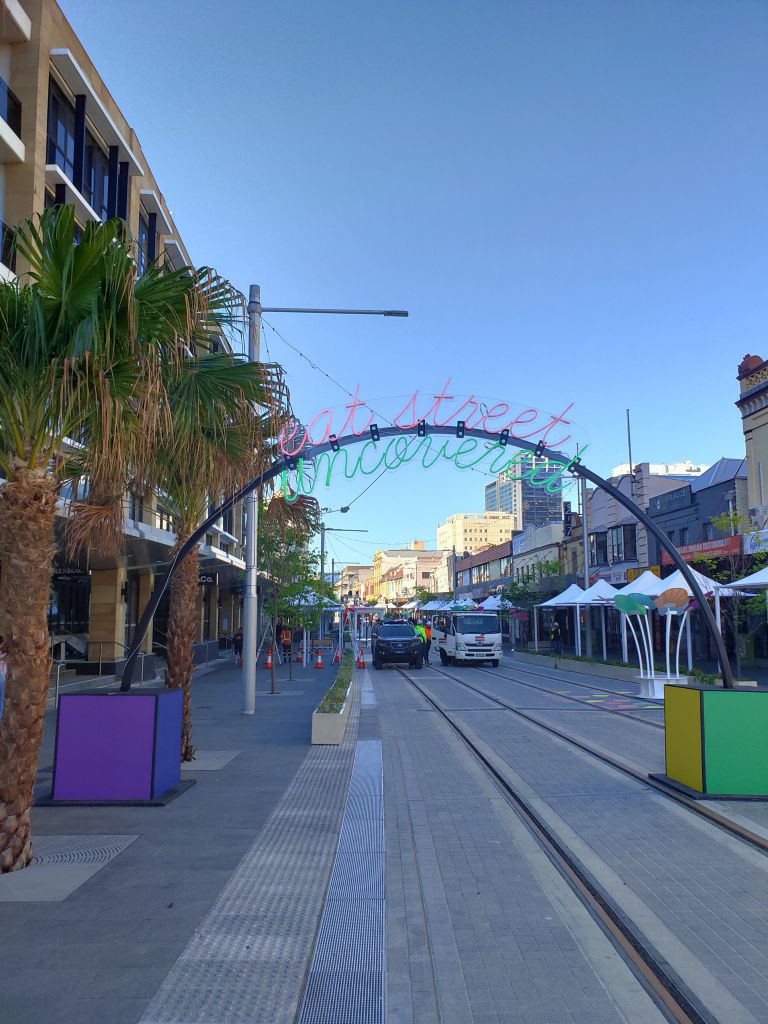 'Eat Street Uncovered' sign on Church Street near Lennox Bridge. Part of the Parramatta Light Rail activation from August 2021 to celebrate the completion of Phase 1.