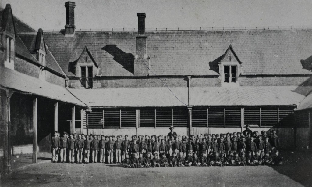 Roman Catholic Orphan School, Parramatta, view of orphan boys assembled in front of two storey building, ca. 1870. Parramatta Heritage Centre LSP650