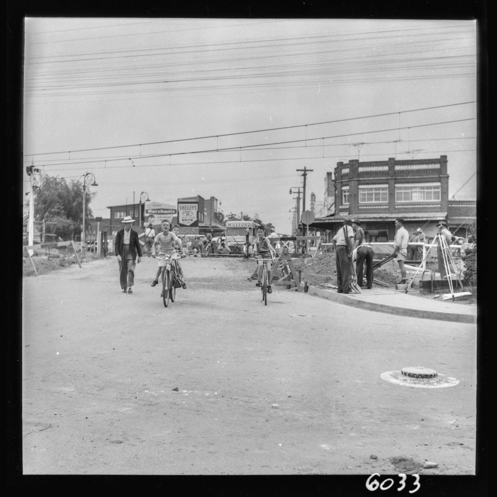 A few carefree friends riding past Guildford railway crossing while construction is underway, circa 1960. City of Parramatta Archives: PRS111/1101.