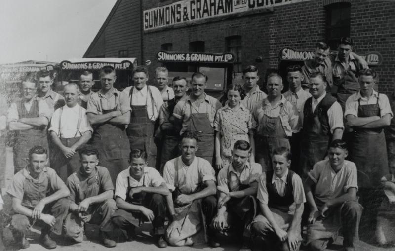 Employees of Summons and Graham Pty Ltd, Dixon Street, Parramatta, assembled in front of commercial vehicles on company premises, ca. 1920s - 1930s (Source: City of Parramatta Local Studies Photograph Collection, LSP01044)