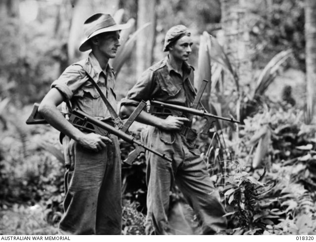 From left: Private Leon Ravet of Parramatta, and Private Bernard Kentwell of Cronulla, on the alert while on patrol duty with their Owen sub machine guns. Source: Australian War Memorial 018320
