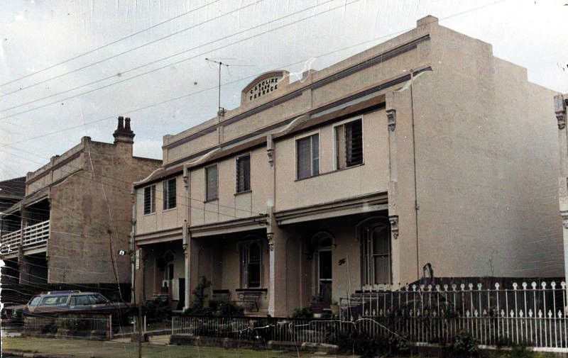Two storey residential terrace buildings, Station Street, Harris Park, ca. 1970s (Source: City of Parramatta, Local Studies Photographic Collection LSP00521, colourised using MyHeritage in Colour https://myhr.tg/1X1AlTlw)