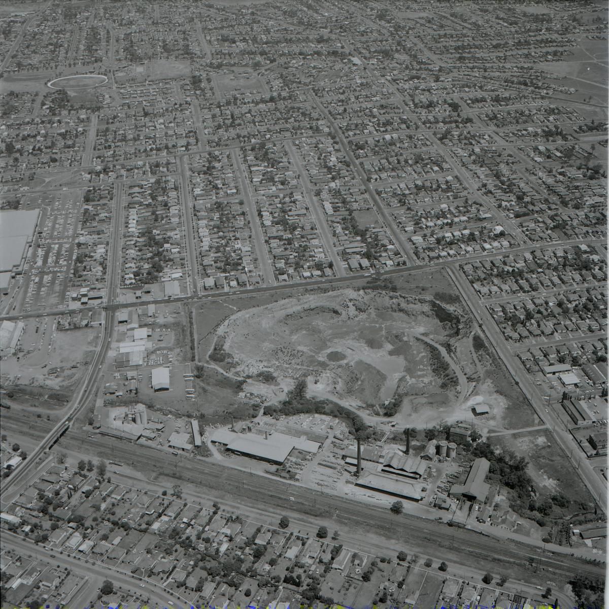 Aerial view of Holroyd Brickworks, today Holroyd Gardens Park; railway line is in the foreground and Merrylands Park is in the background. Source: Community Archives Collection ACC002/103/005