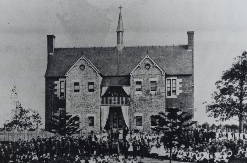 Roman Catholic Orphan School, Parramatta, view of staff and orphans assembled in front of two storey brick building, ca. 1870s – 1880s (Source: City of Parramatta Council, Local Studies Photographic Collection, LSOP00831)