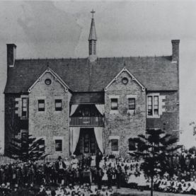 Roman Catholic Orphan School, Parramatta, view of staff and orphans assembled in front of two storey brick building, ca. 1870s – 1880s (Source: City of Parramatta Council, Local Studies Photographic Collection, LSOP00831)