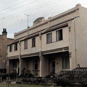 Two storey residential terrace buildings, Station Street, Harris Park, ca. 1970s (Source: City of Parramatta, Local Studies Photographic Collection LSP00521, colourised using MyHeritage in Colour https://myhr.tg/1X1AlTlw)