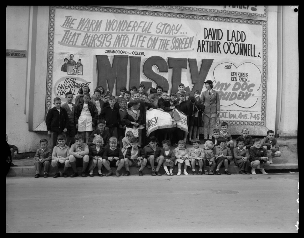 Children are standing in front of a big advertisement of film "Misty" the Pony outside Roxy theatre, Parramatta, 1961. ACC002/31/3. Elton Ward Collection, Parramatta Heritage Centre.